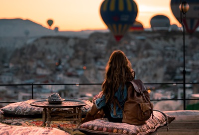 Woman looking at a bunch of air balloons.