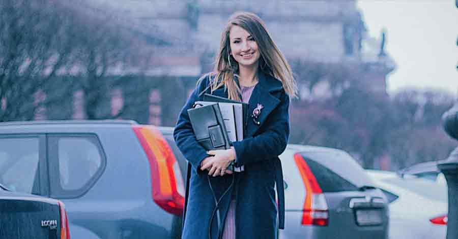 A photo of a woman holding important documents